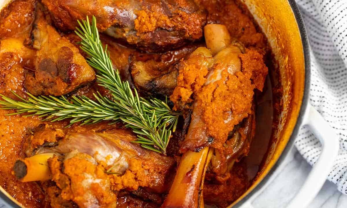 Close up of Braised Lamb Shank in a cooking pot.