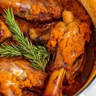 Close up of Braised Lamb Shank in a cooking pot.