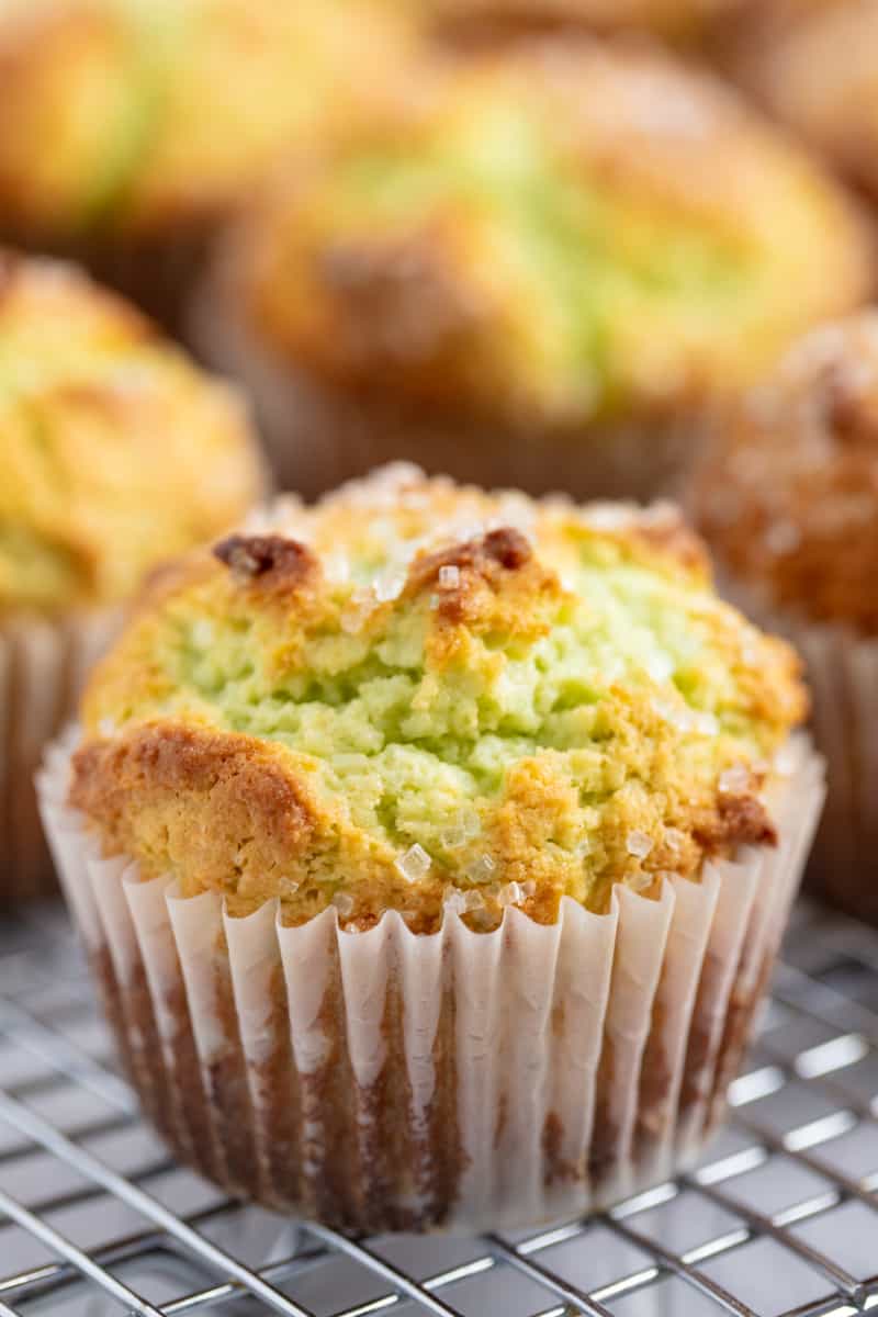 Close up of Pistachio Muffins on a wire rack.