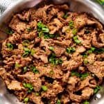 Mongolian Beef in a stainless teel frying pan.