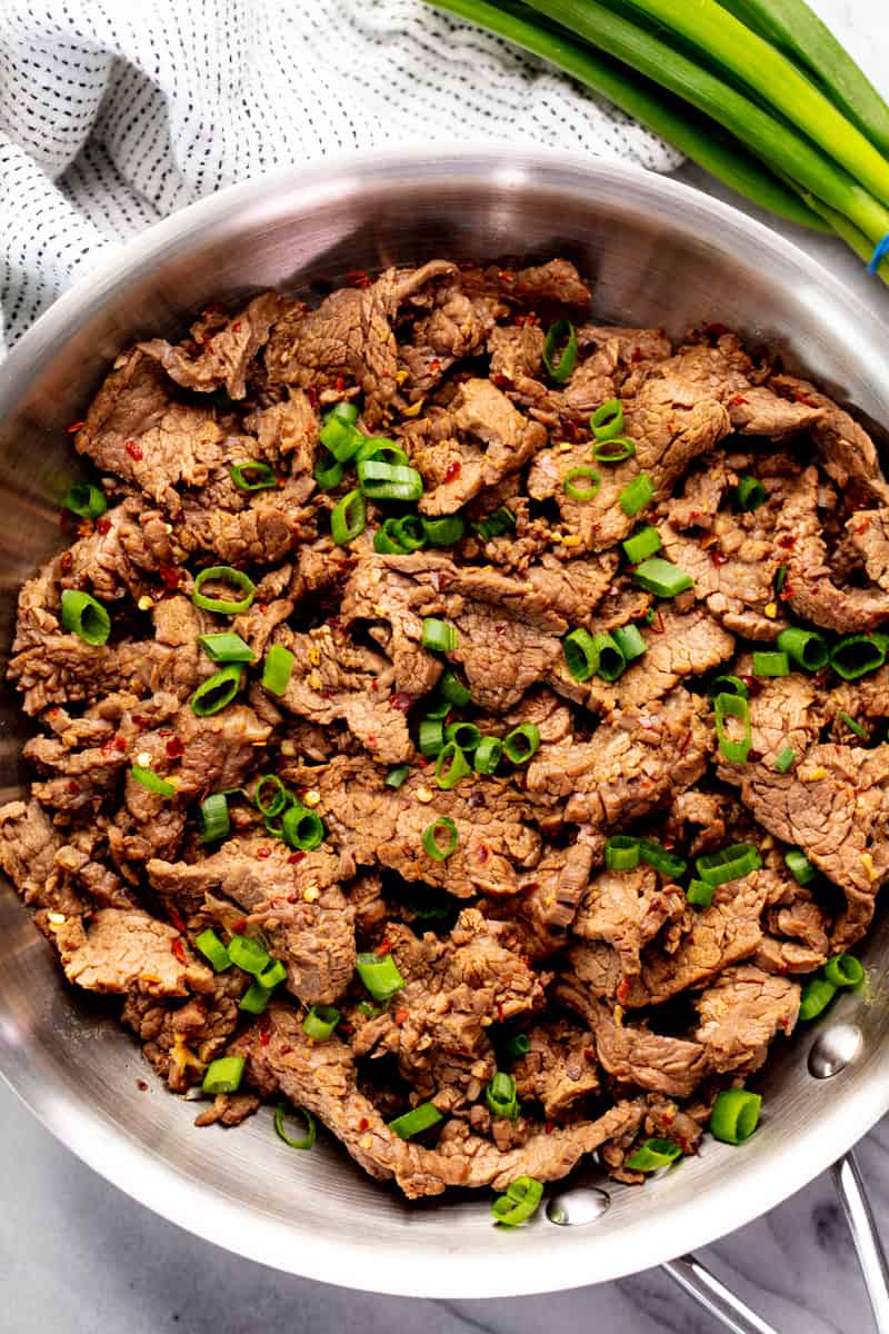 Mongolian Beef in a stainless teel frying pan.