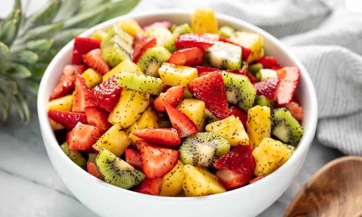 Angled view of Summer Fruit Salad in a white bowl.