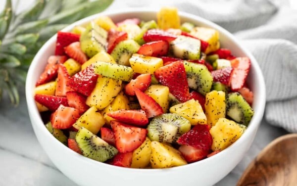 Angled view of Summer Fruit Salad in a white bowl.