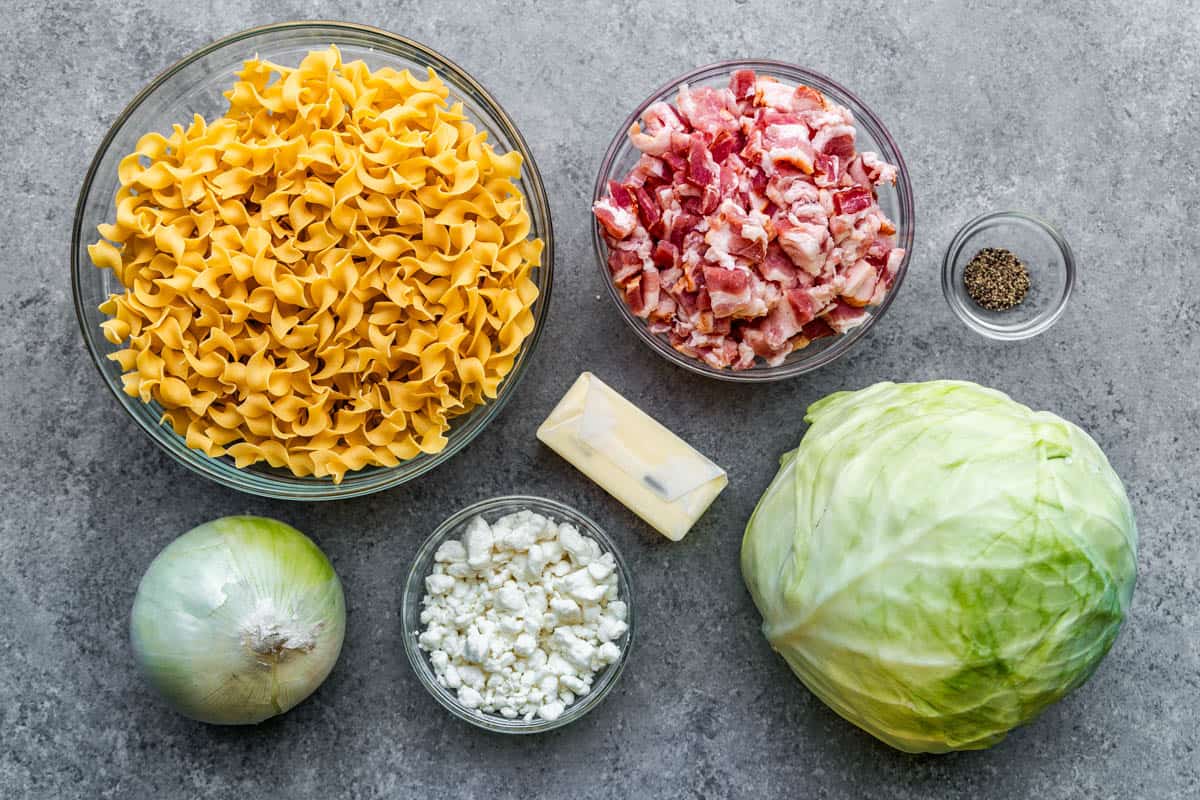 Bowl filled with ingredients next to a head of cabbage.