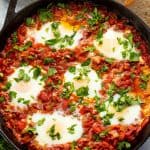 Bird's eye view of Shakshuka in a cast iron skillet.