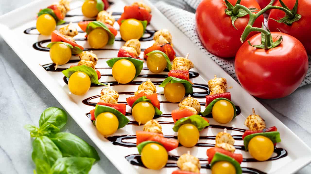 Angled view of Southwestern Caprese Bites on a white serving plate.