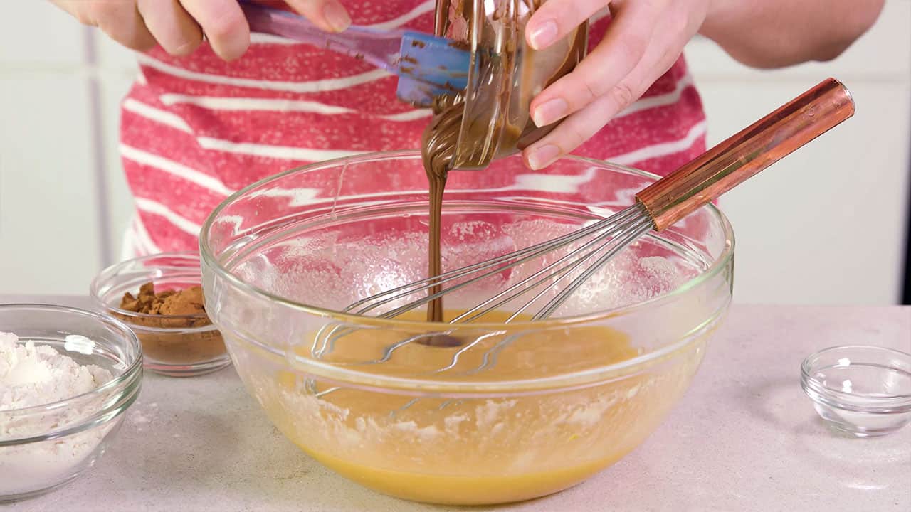 Add melted chocolate to wet ingredients in mixing bowl.