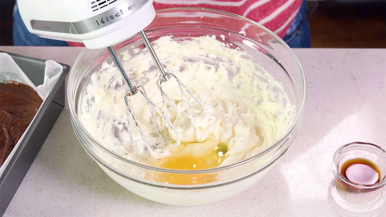 Mix eggs with cream cheese to make cheesecake mixture in mixing bowl.
