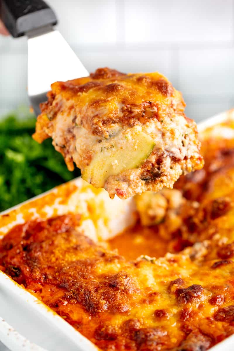 Slice of Zucchini Lasagna being pulled out of the cooking dish by a spatula.