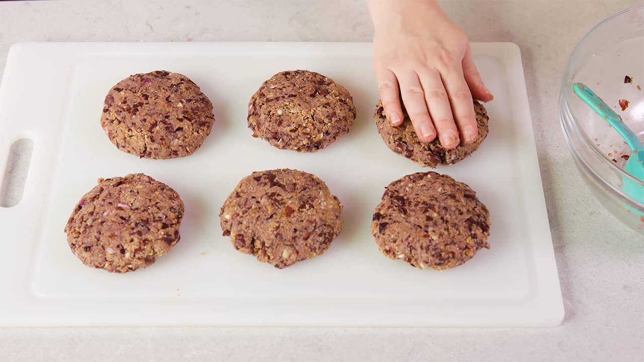 Shape the black bean mix from the mixing bowl into burger shaped patties onto a cutting board.