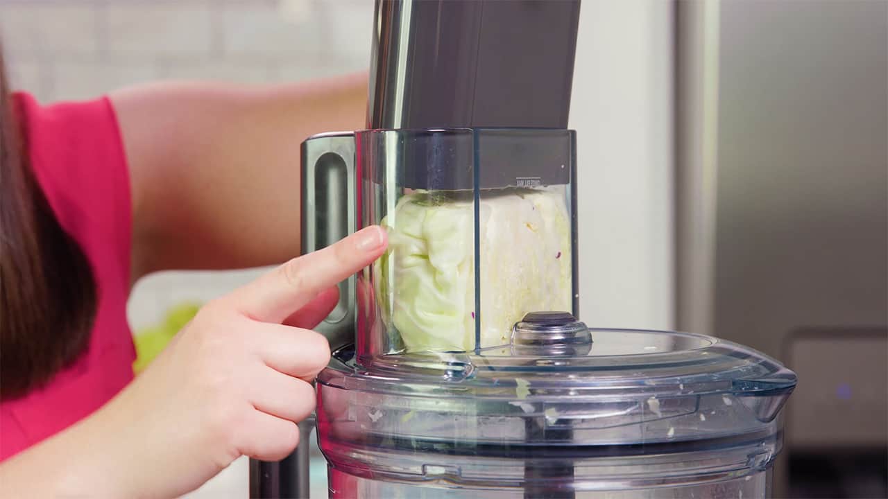 Using a food processor, finely chop green cabbage to desired amount.