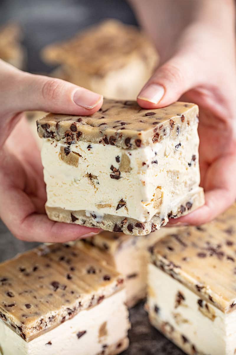 Cookie Dough Ice Cream Sandwiches being held in both hands.