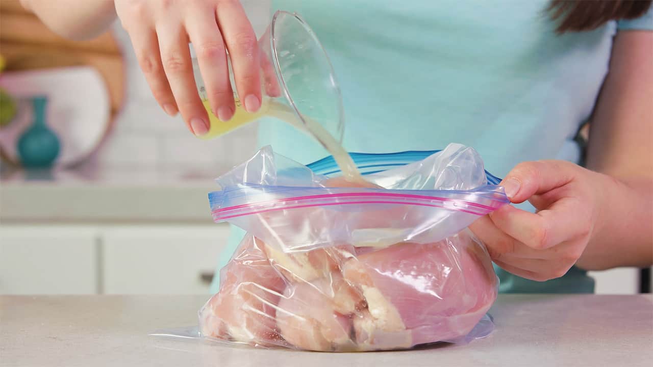 Using gallon sized lear plastic bag, filled with chicken breasts, add freshly squeezed lime juice.