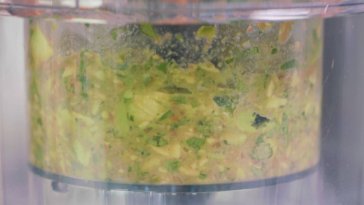 A close-up view of the interior of a good process with added ingredients for guacamole.