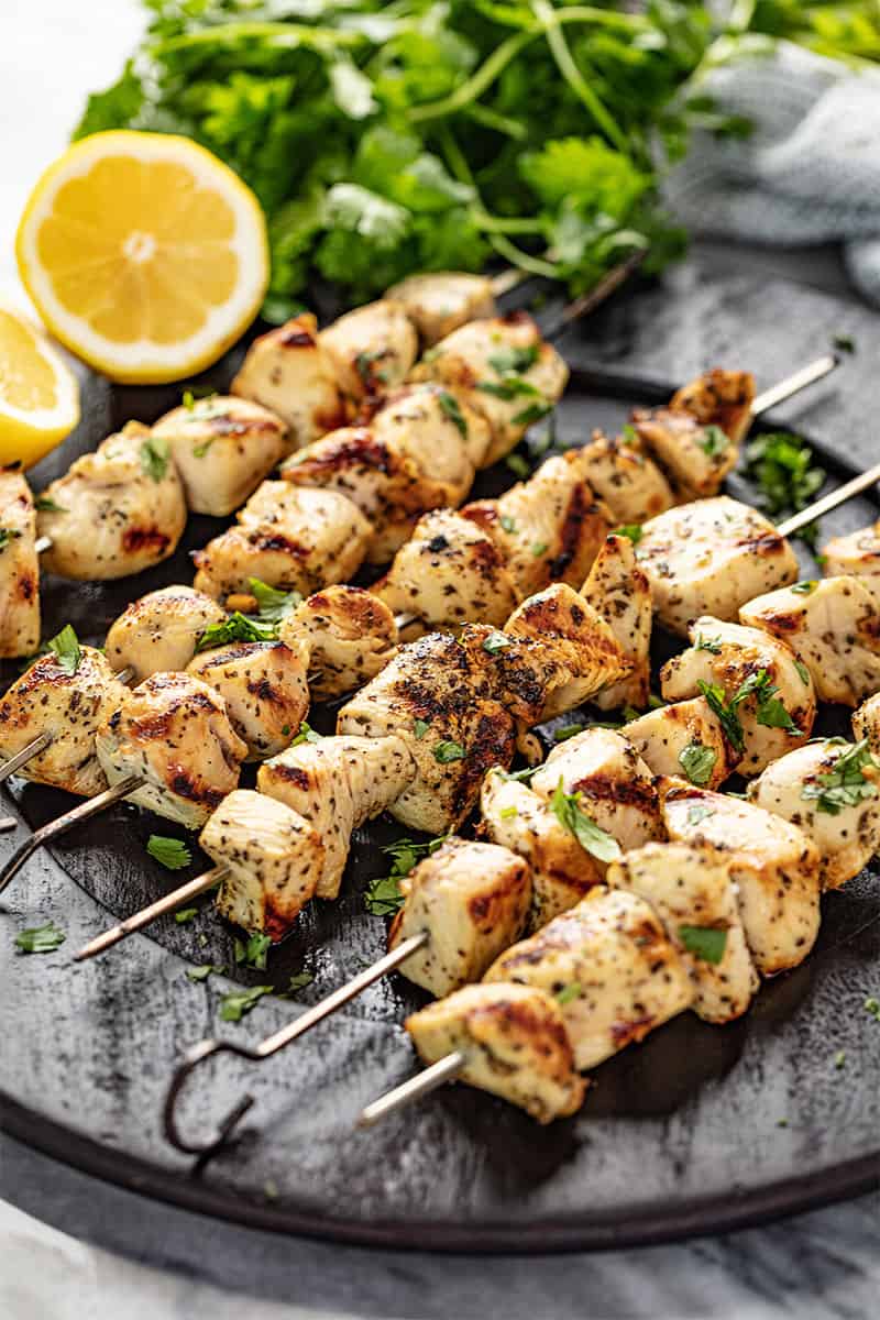 Lemon Chicken Kabobs on a black plate.