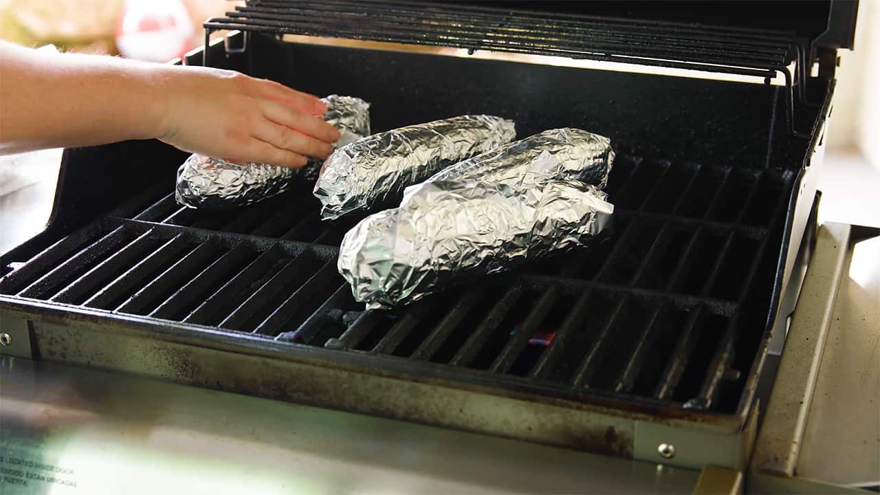 Place each foil wrapped corn cob on the grill for suggested time.