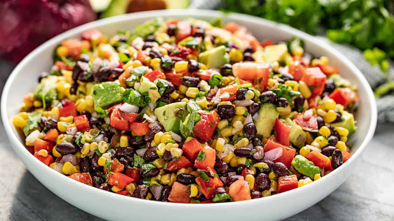 Simple black bean and corn salad in a white serving bowl