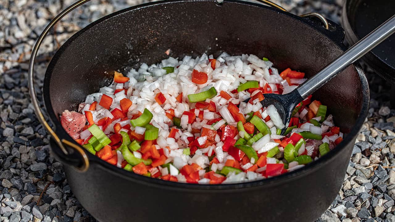 Saute veggies in cast iron dutch oven on charcoal