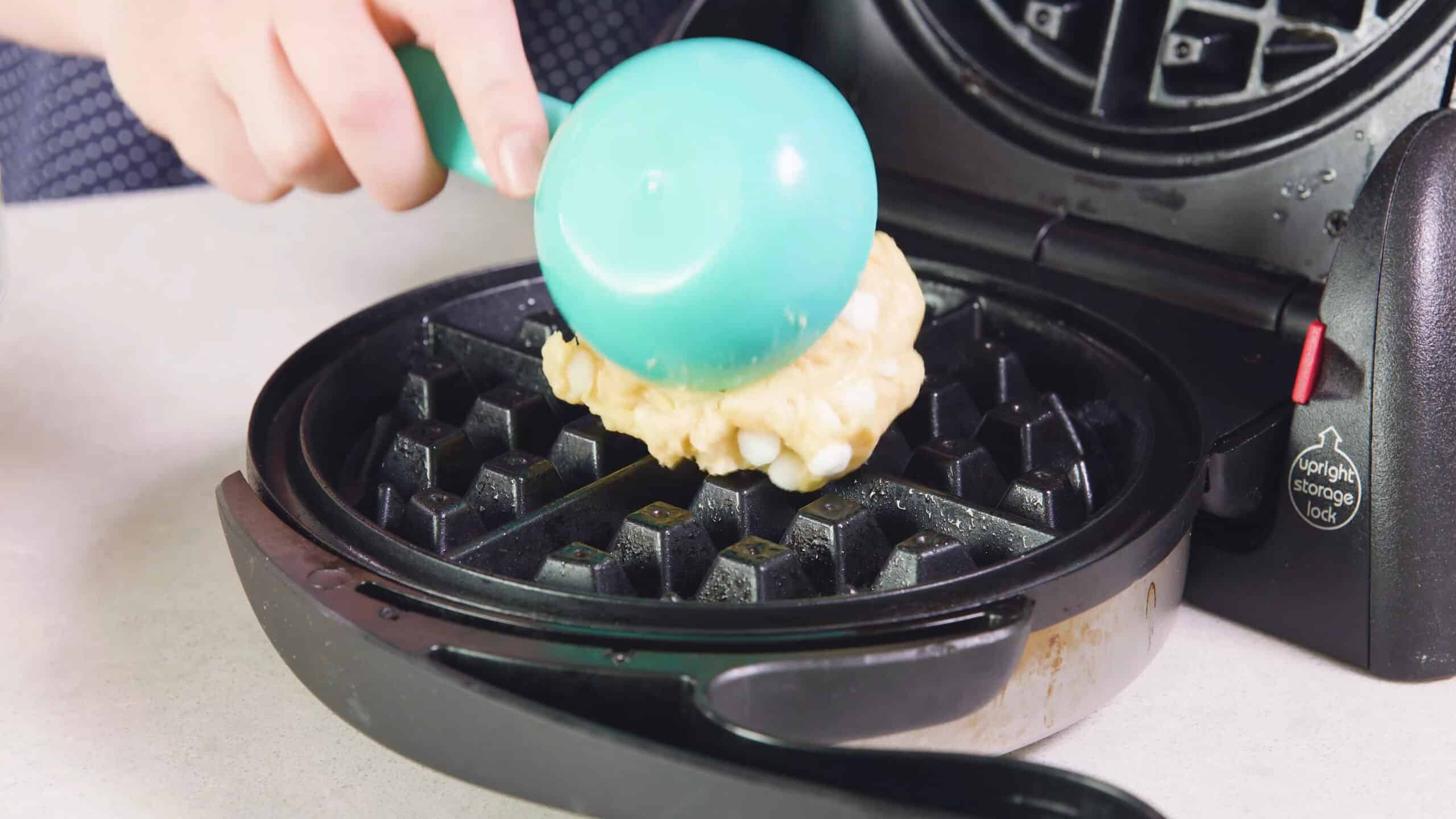 Using a one third of a cup measuring cup, portion out the batter into a greased waffle maker.
