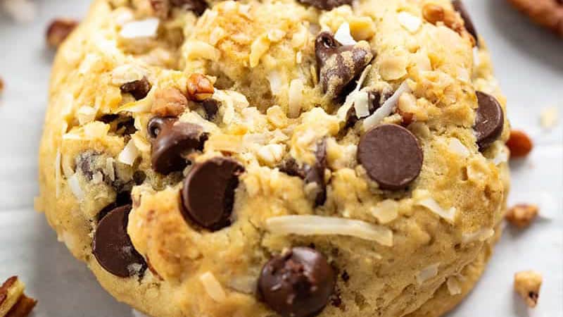 Close up of a cowboy cookie with chocolate chips and coconut flakes