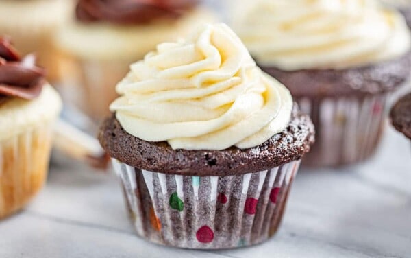sweetened condensed milk frosting on a chocolate cupcake