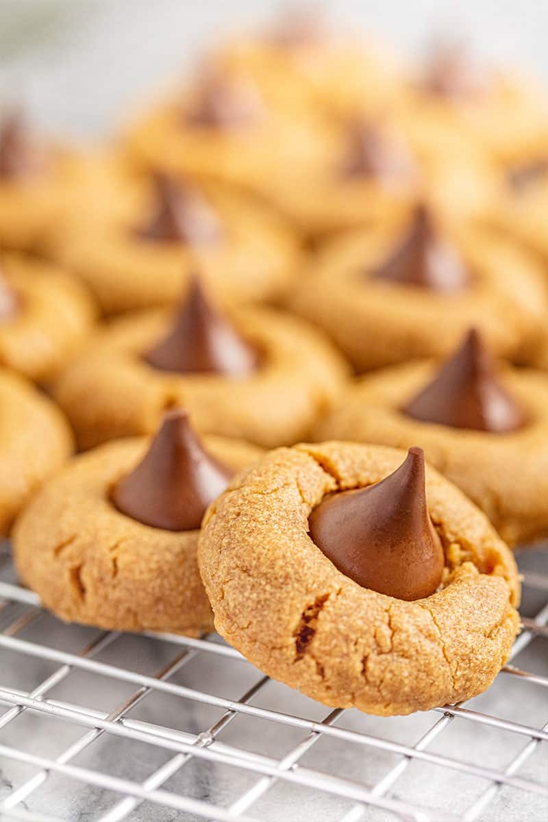 Close up of Peanut Butter Kiss Cookies on a wire cooling rack.