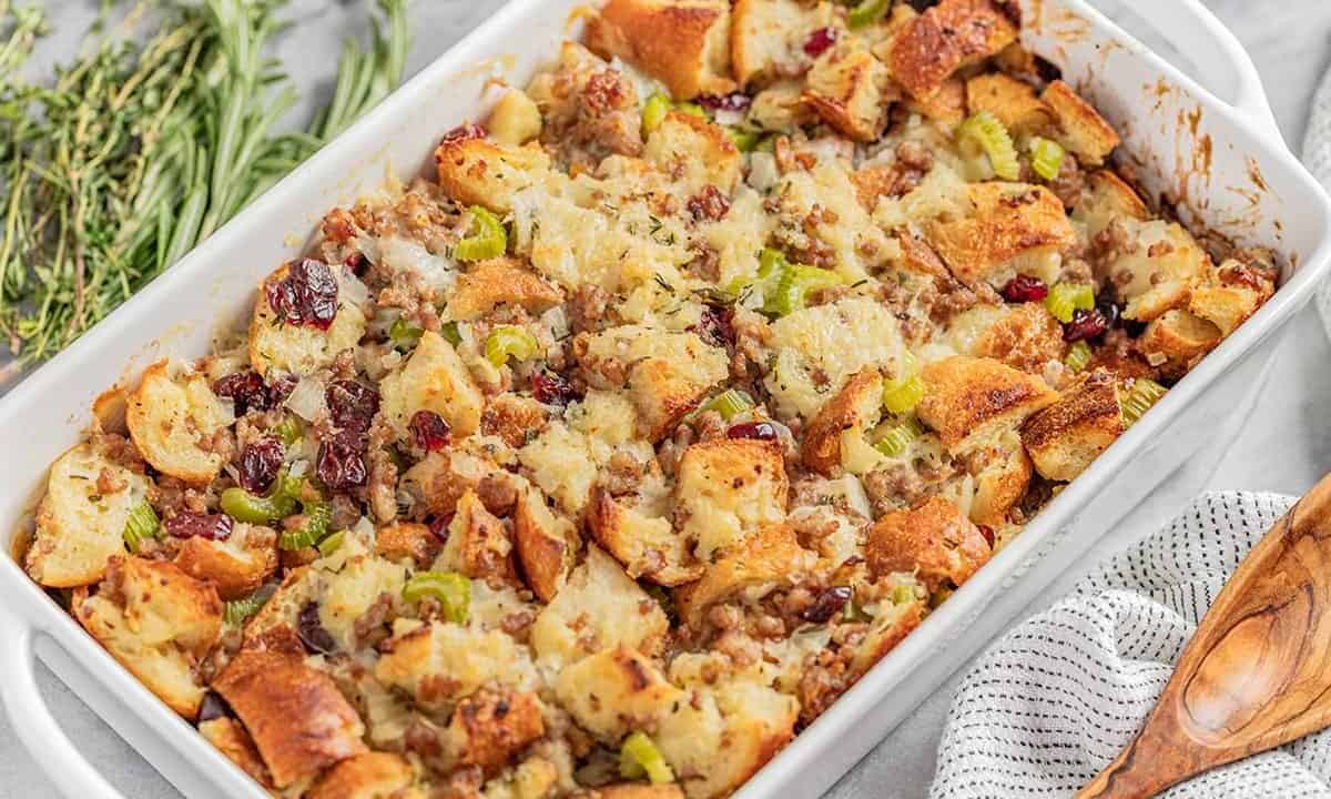 Angled view of Sausage Stuffing in a white serving dish.