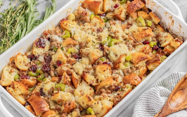Angled view of Sausage Stuffing in a white serving dish.