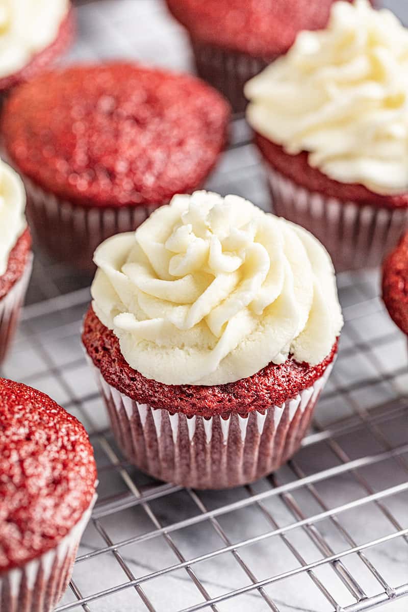 Red Velvet Cupcakes with Ermine Icing on a wire cooling rack