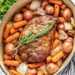 Pork Roast, carrots, baby red potatoes, and onion in a cast iron dutch oven