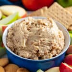 Toffee Apple Dip in a bowl surrounded by apple slices, graham crackers, and nilla wafers