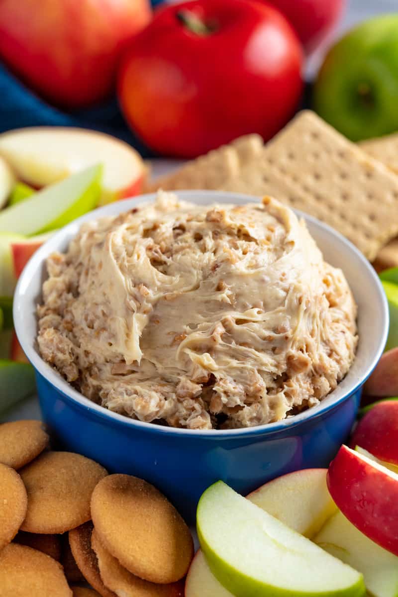 Toffee Apple Dip in a bowl surrounded by apple slices, graham crackers, and nilla wafers