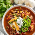 Taco Soup topped with grated cheese, jalapeno and sour cream