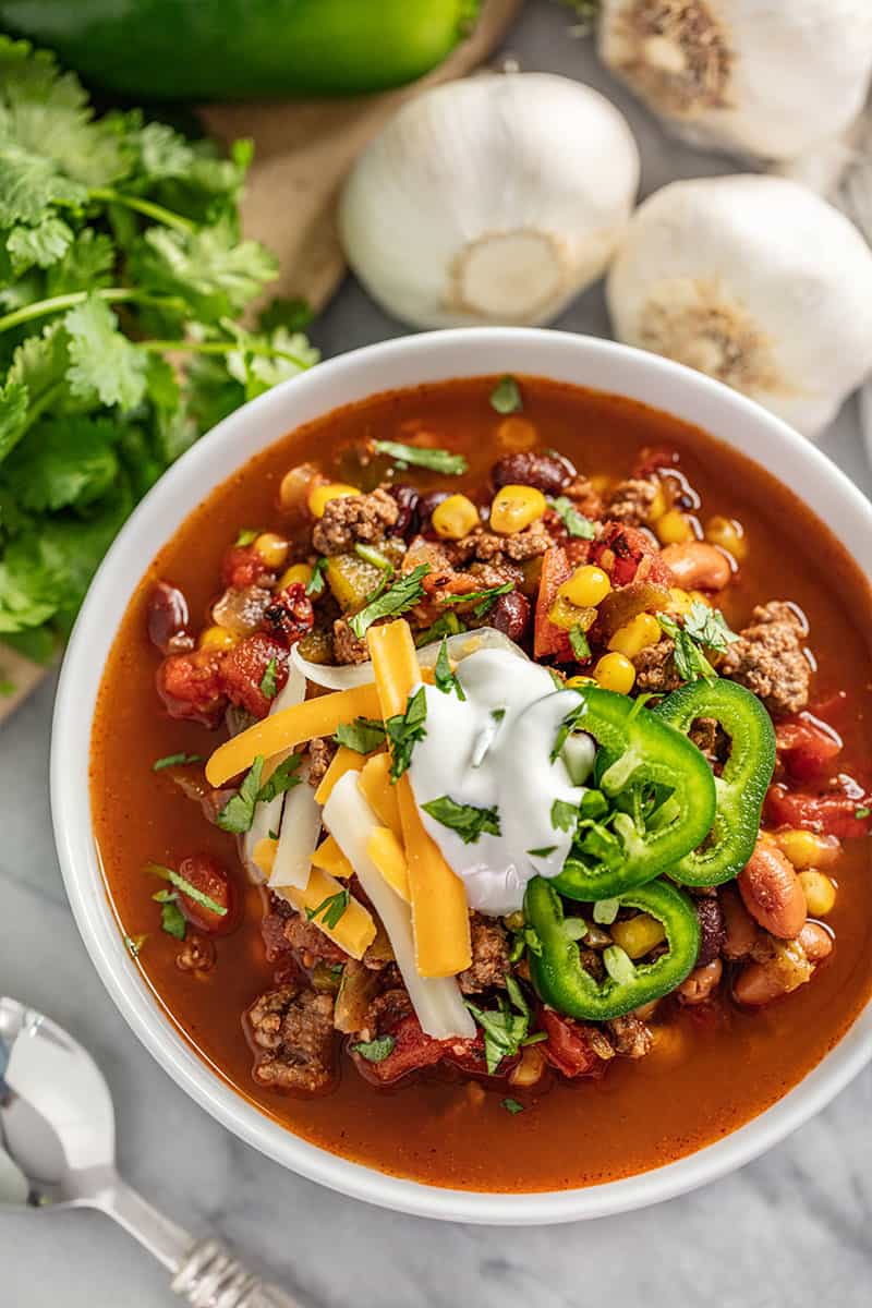 30 minute Taco Soup topped with grated cheese, jalapeno and sour cream