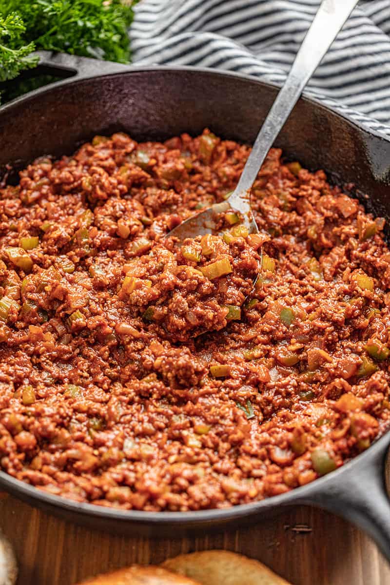 Sloppy Joe meat and veggie mix in skillet with spoon