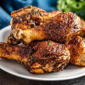 Cajun Chicken Drumsticks piled up on a white plate