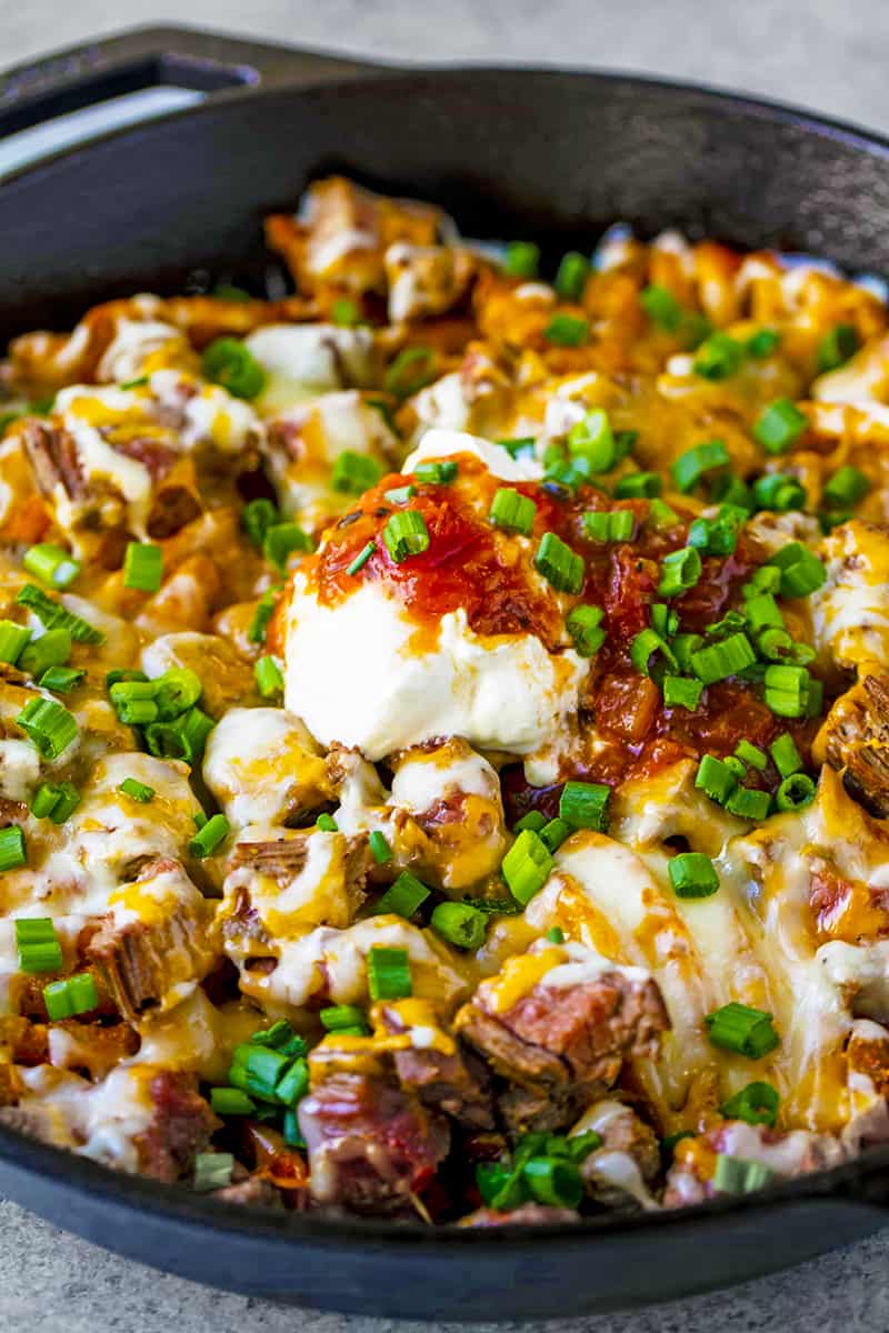 Close up of Steak and Potato Nachos in a skillet.