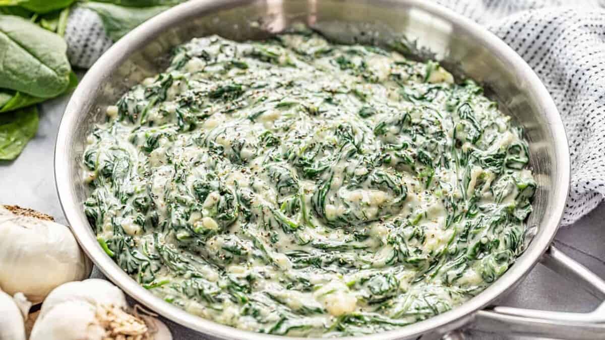 Creamed spinach in a stainless steel skillet