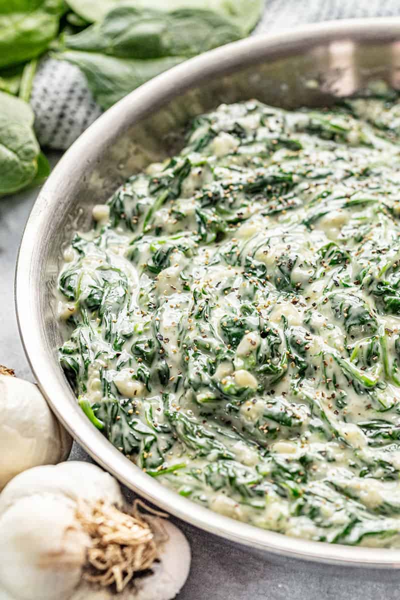 Creamed spinach in a stainless steel skillet