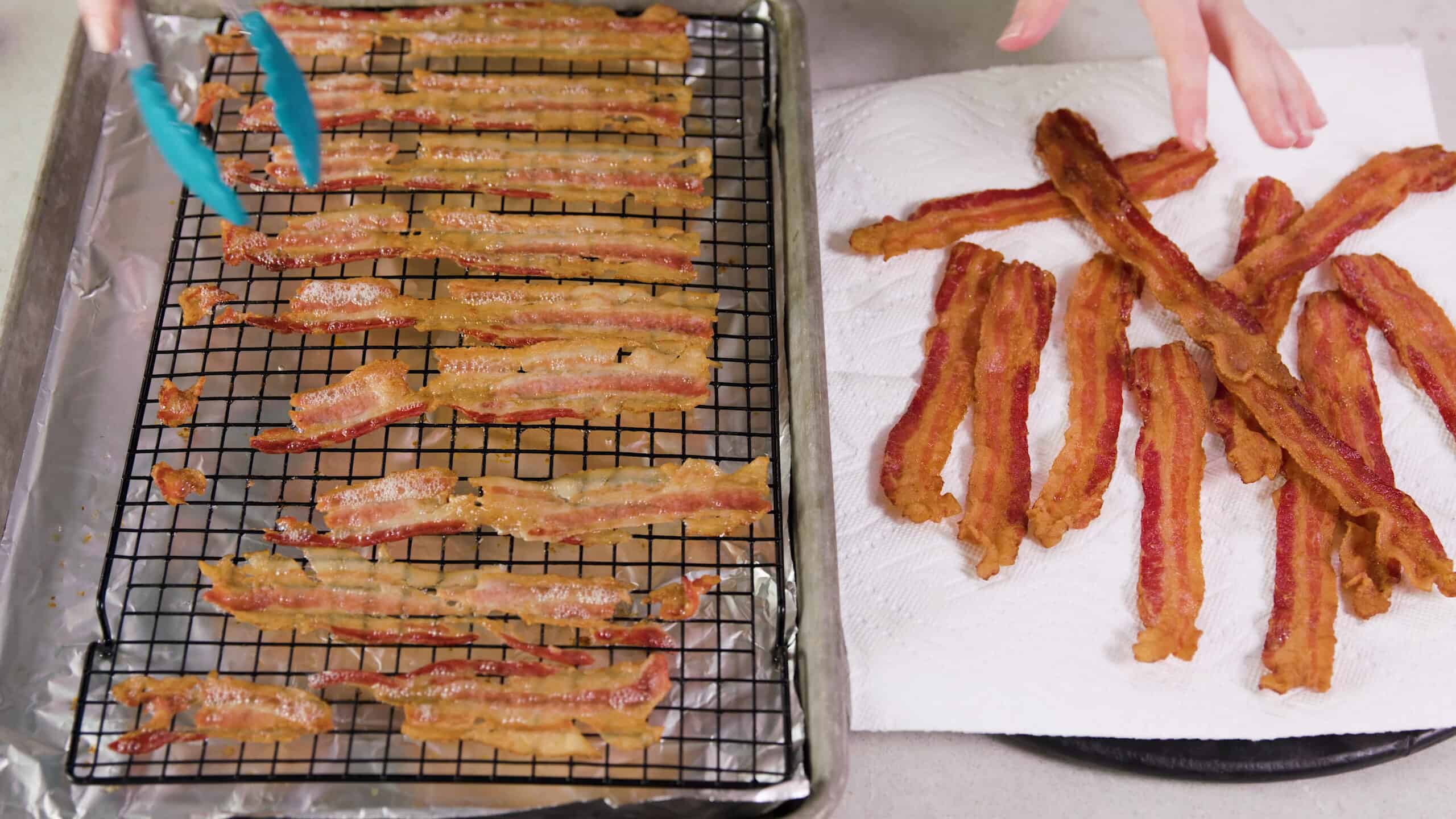 Overhead view of a side by side comparison of cracked broken bacon on a cooling rack inside a metal baking sheet lined with aluminum foil on the left compared to the full strips of golden brown bacon resting on a paper towel covered plate on the right.