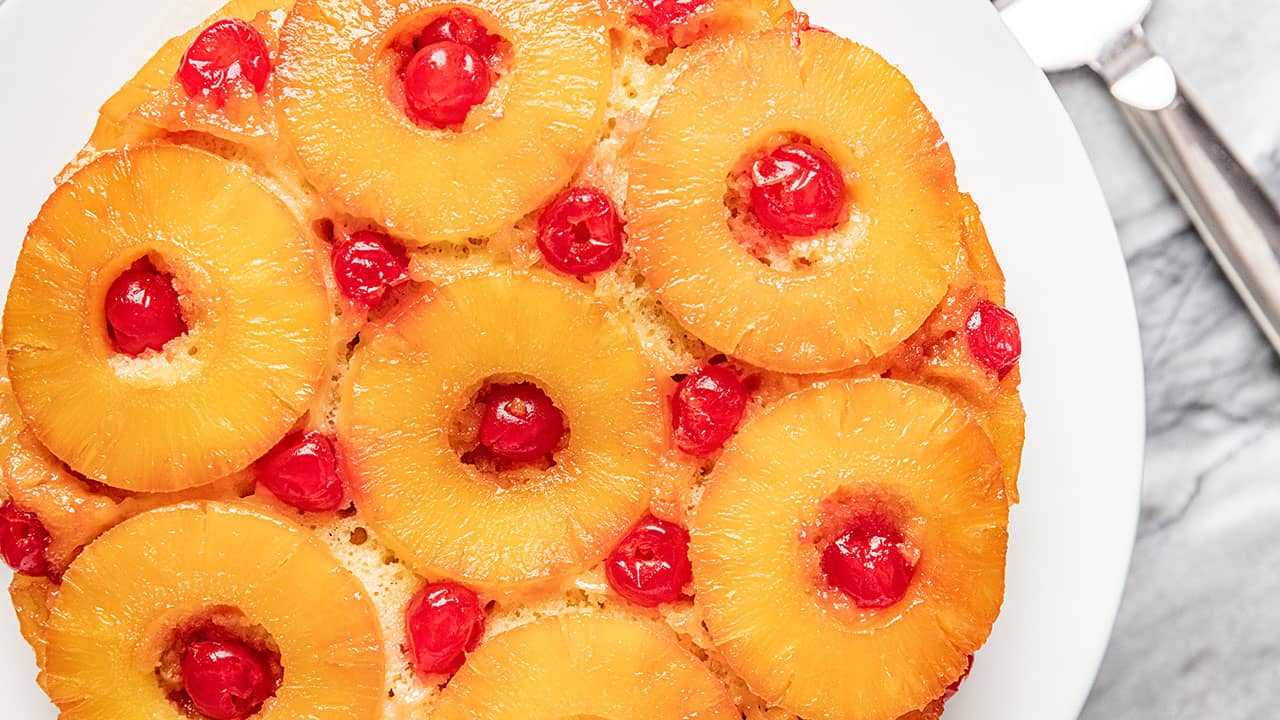 Pineapple upside down cake on a white cake plate