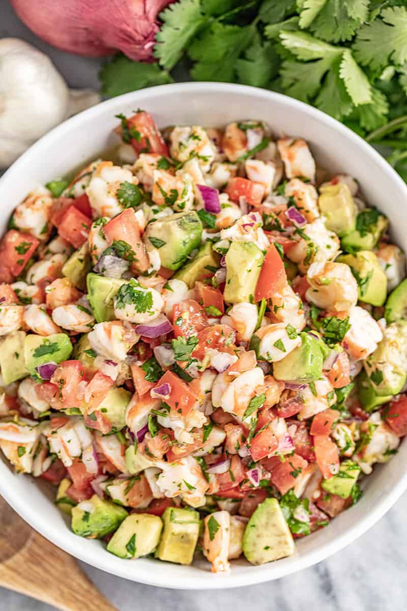 Shrimp ceviche with cilantro on top in white bowl