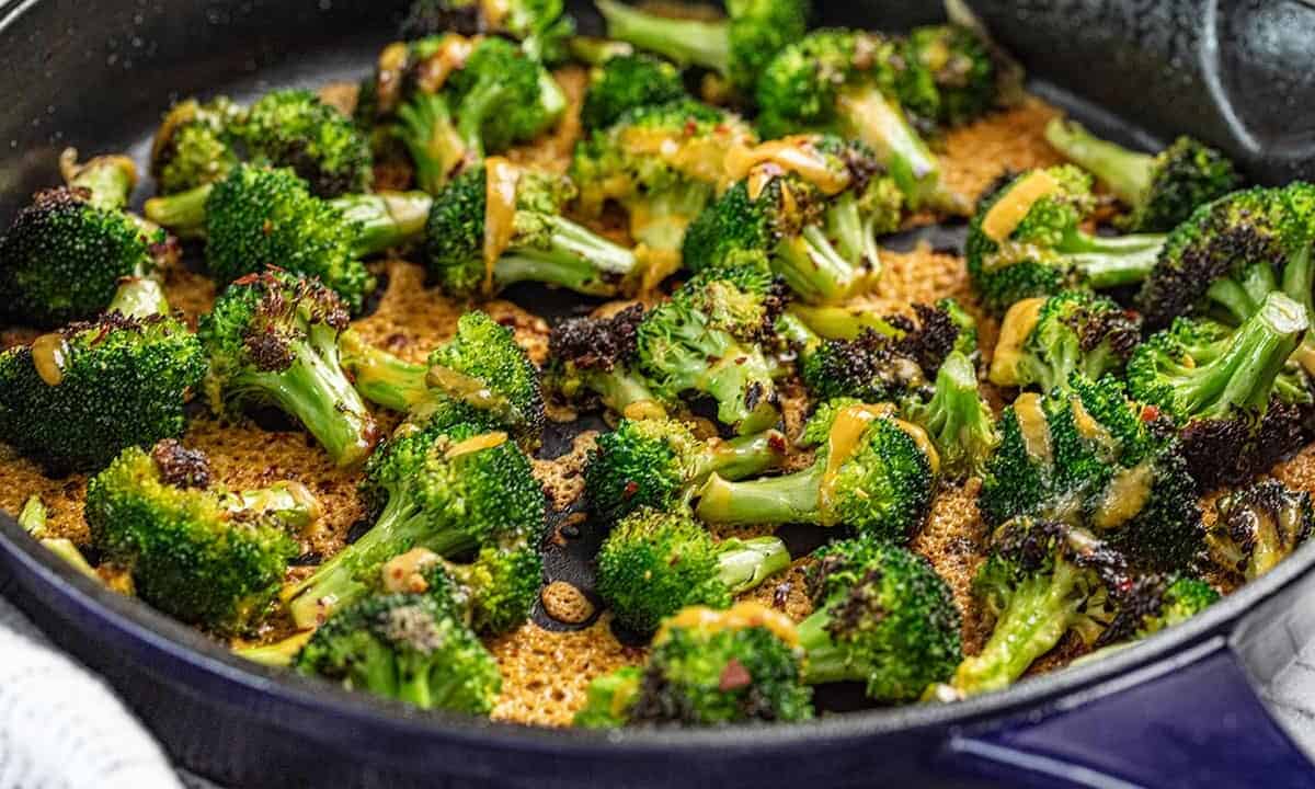 Cheesy broccoli in a blue skillet