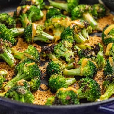 Cheesy broccoli in a blue skillet