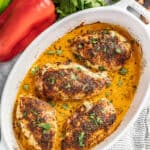 Cajun stuffed chicken breasts in a white baking dish