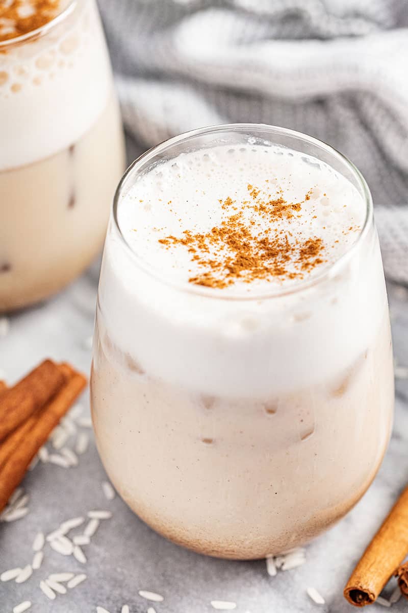 Glass of Mexican horchata with cinnamon sprinkled on top