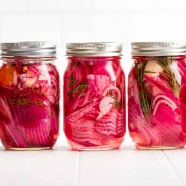 A row of five jars of pickled onions.