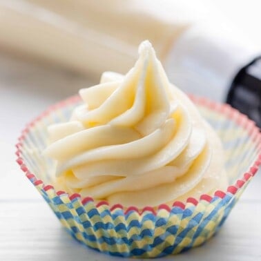 Cream cheese frosting in a cupcake liner.