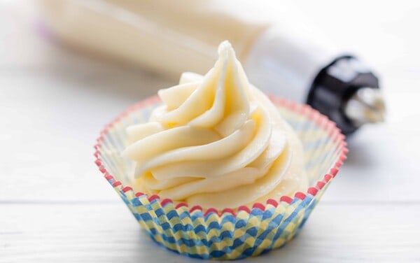 Cream cheese frosting in a cupcake liner.