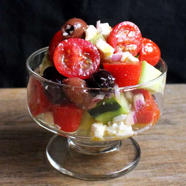 Glass bowl filled with greek salad